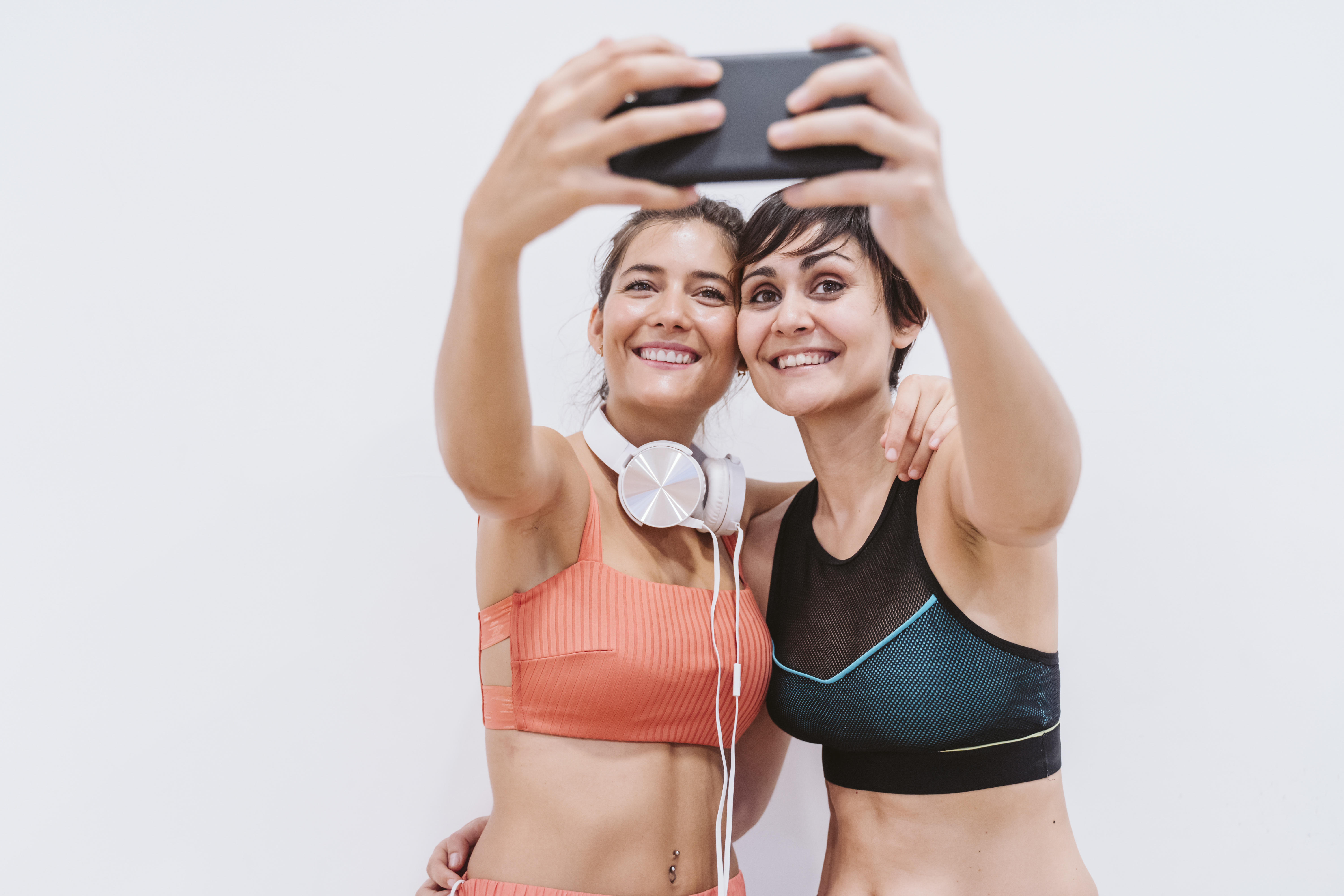Two Friends Women At The Gym Taking A Selfie With Mobile Phone Smiling Happily Technology 